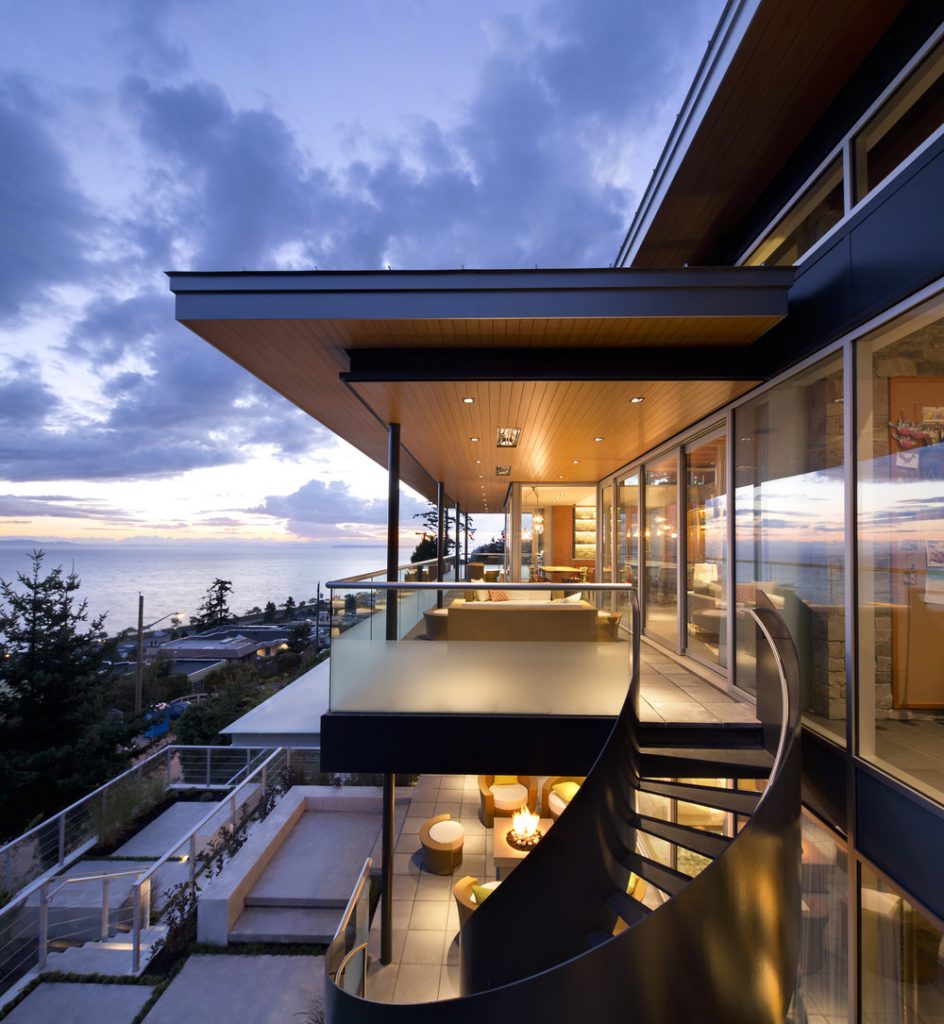 Picture of the outside of a high-end building featuring a balcony & spiral stair case. Exterior Panels & soffit are all provided by Longboard Architectural Products.